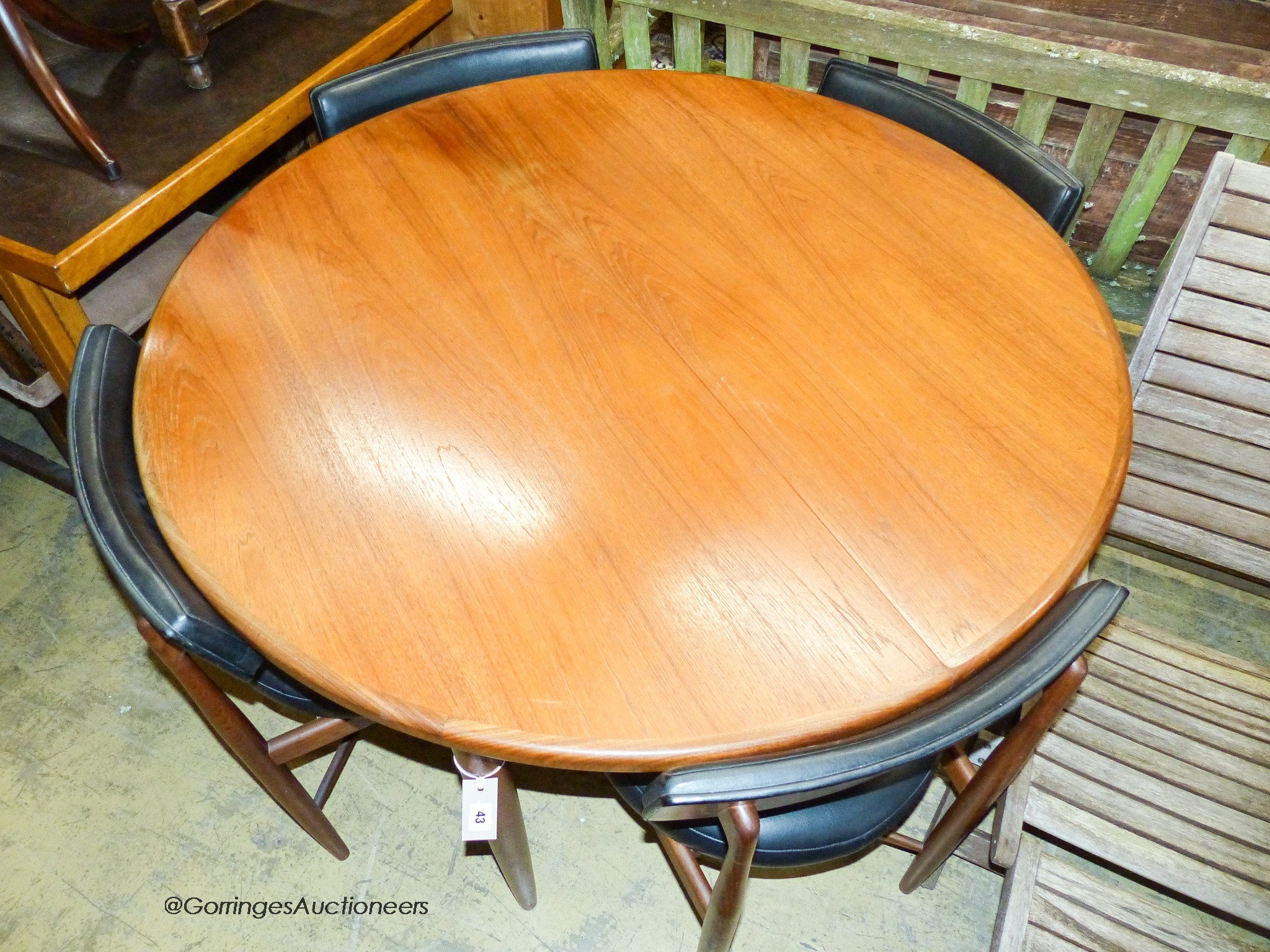 A teak and leatherette Fresco dining suite by Wilkins for G Plan, comprising circular extending dining table, 120cm diameter (166cm extended), height 73cm and four chairs